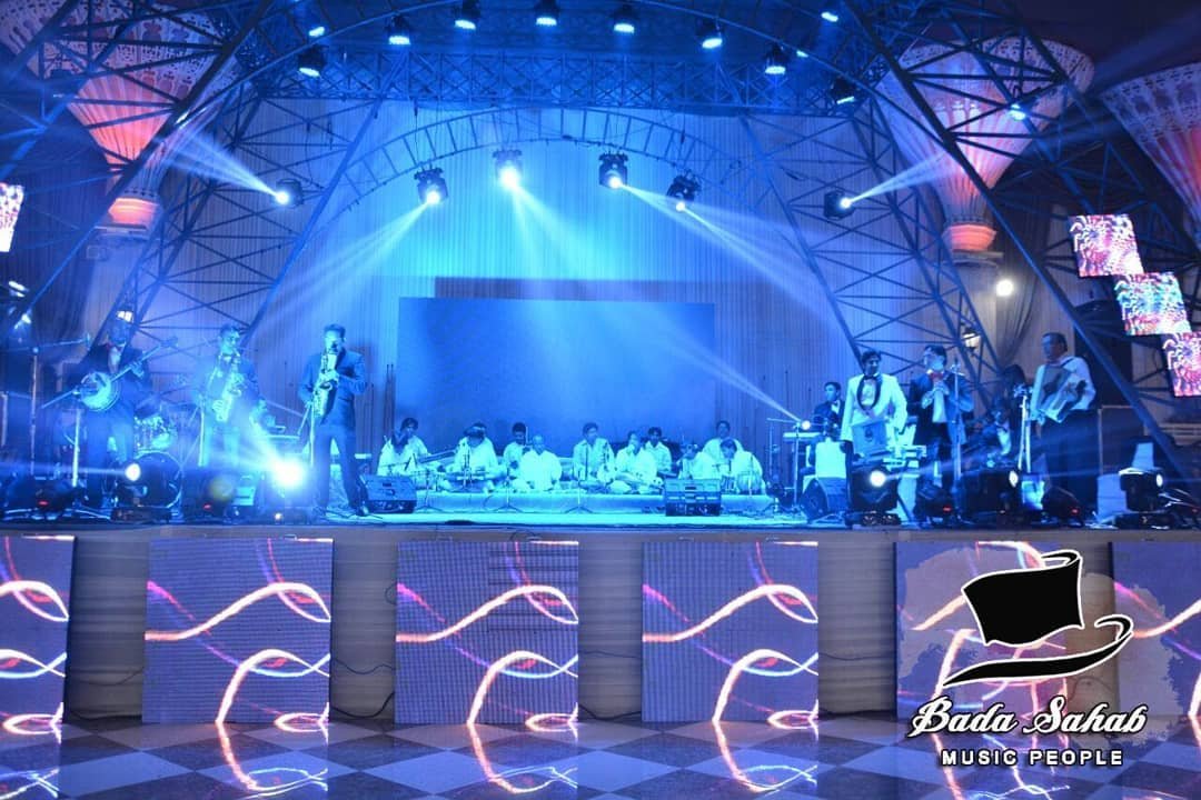 Wide concert stage with live musicians and LED lights